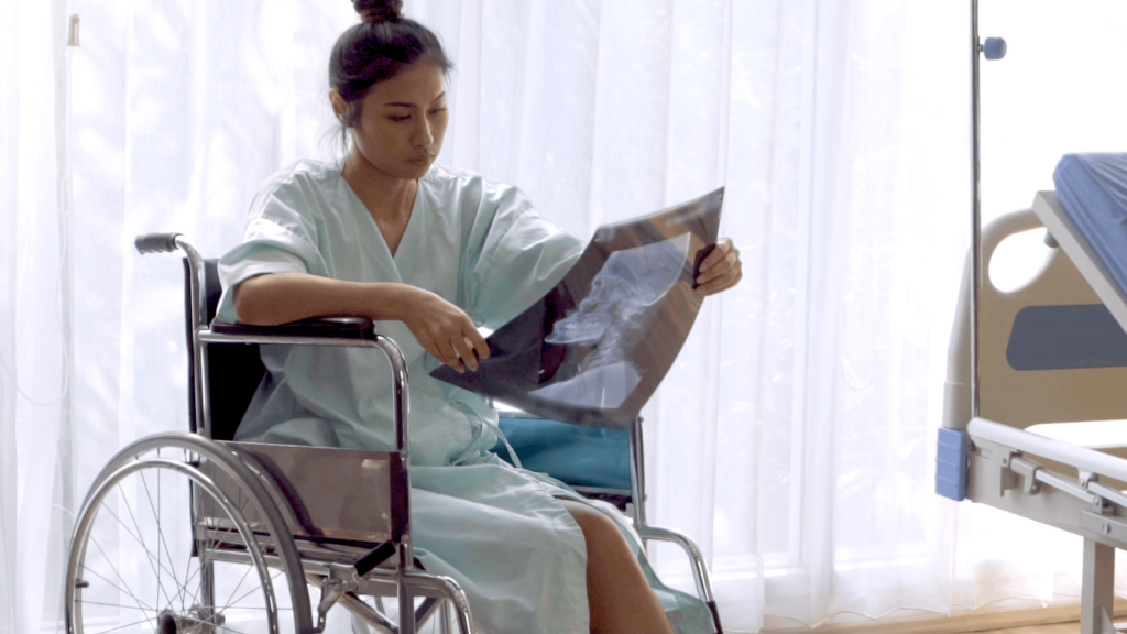 A woman in a wheelchair scanning her X-ray