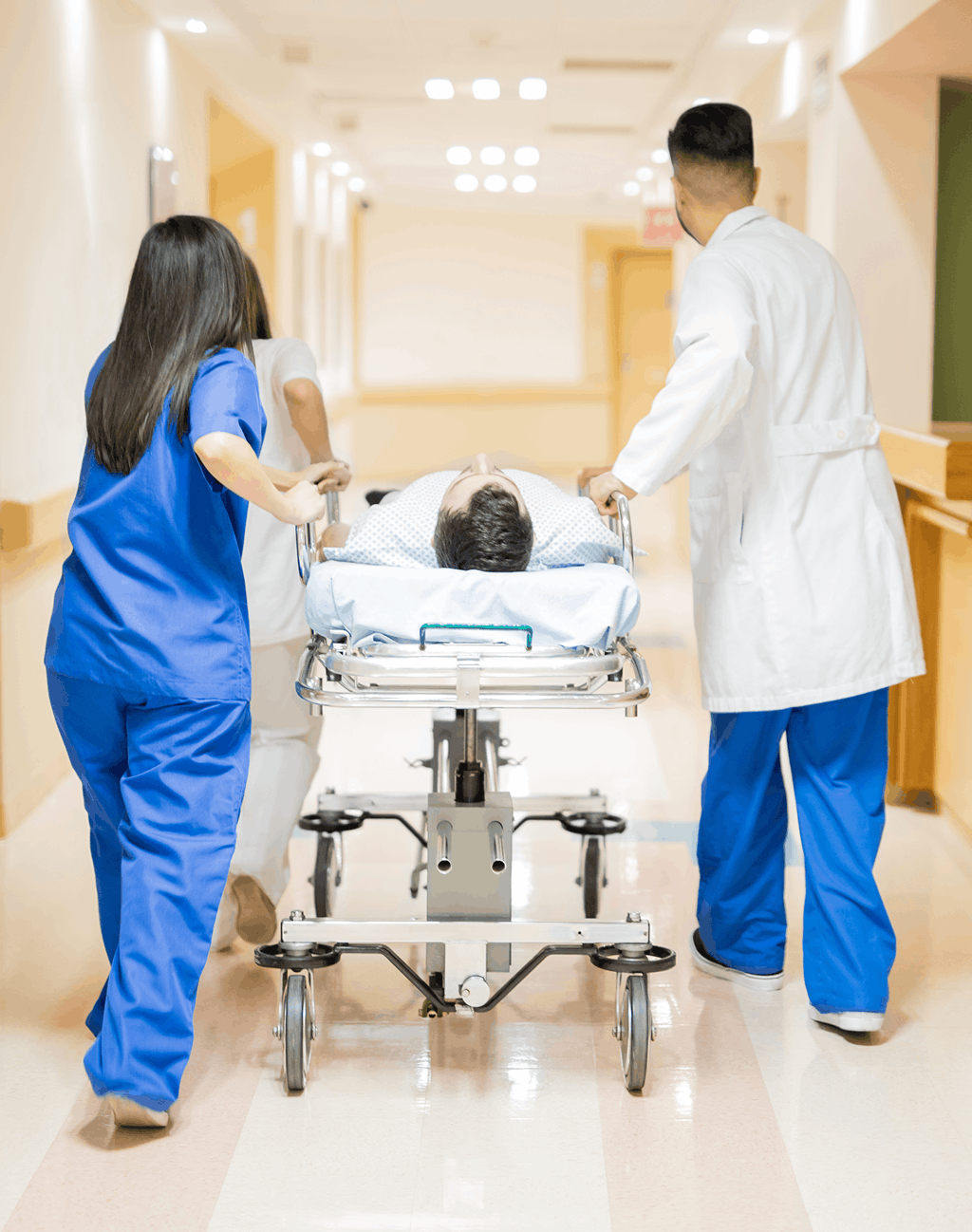 doctors wheeling patient on a hospital bed