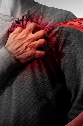 Person clutching chest with red overlay effect, depicting heart pain or cardiac distress